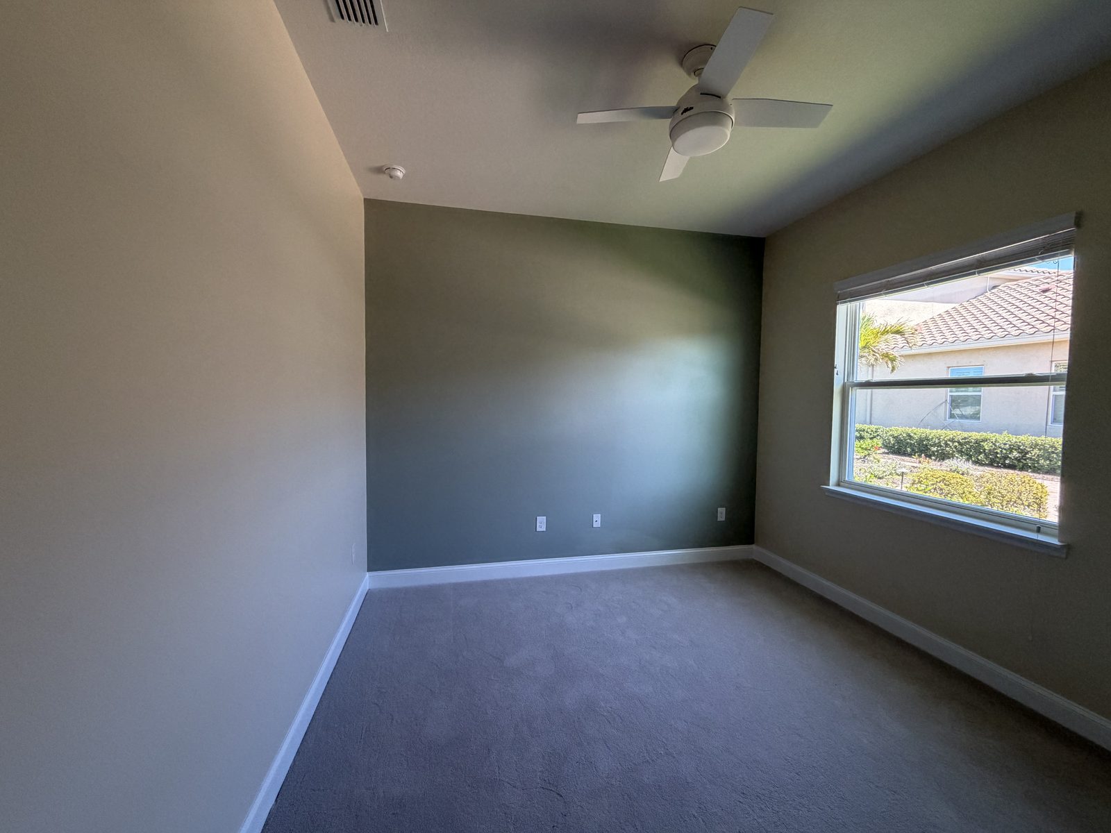 Freshly painted room with smooth warm-greige walls, soft window light, and clean trim